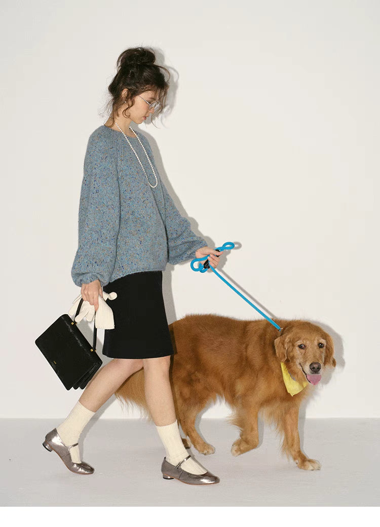 Crystal blue confetti knit sweater worn while walking a dog showcasing oversized silhouette and everyday styling