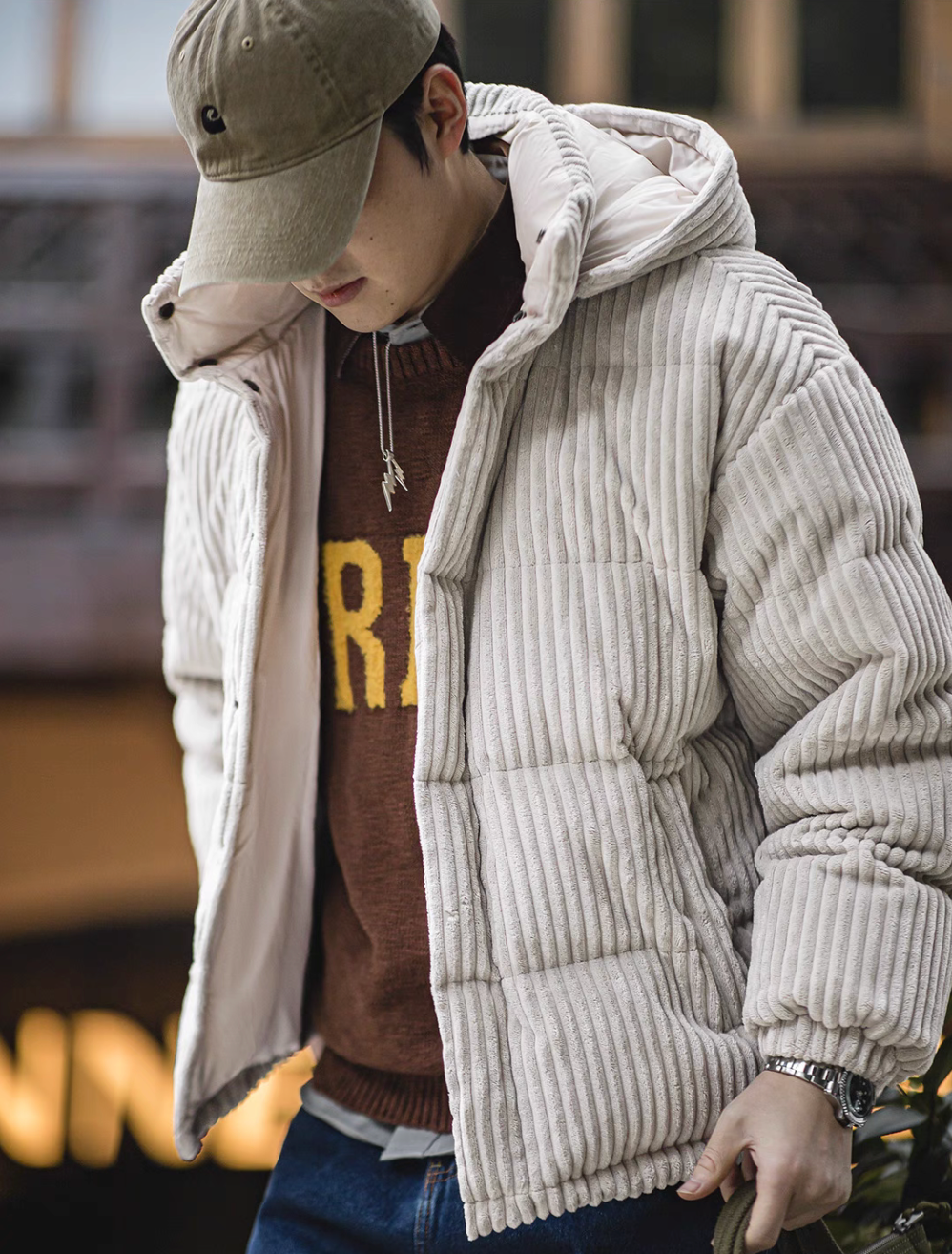 Side view of Misty Gray corduroy down jacket worn by model highlighting ribbed texture and layered winter styling