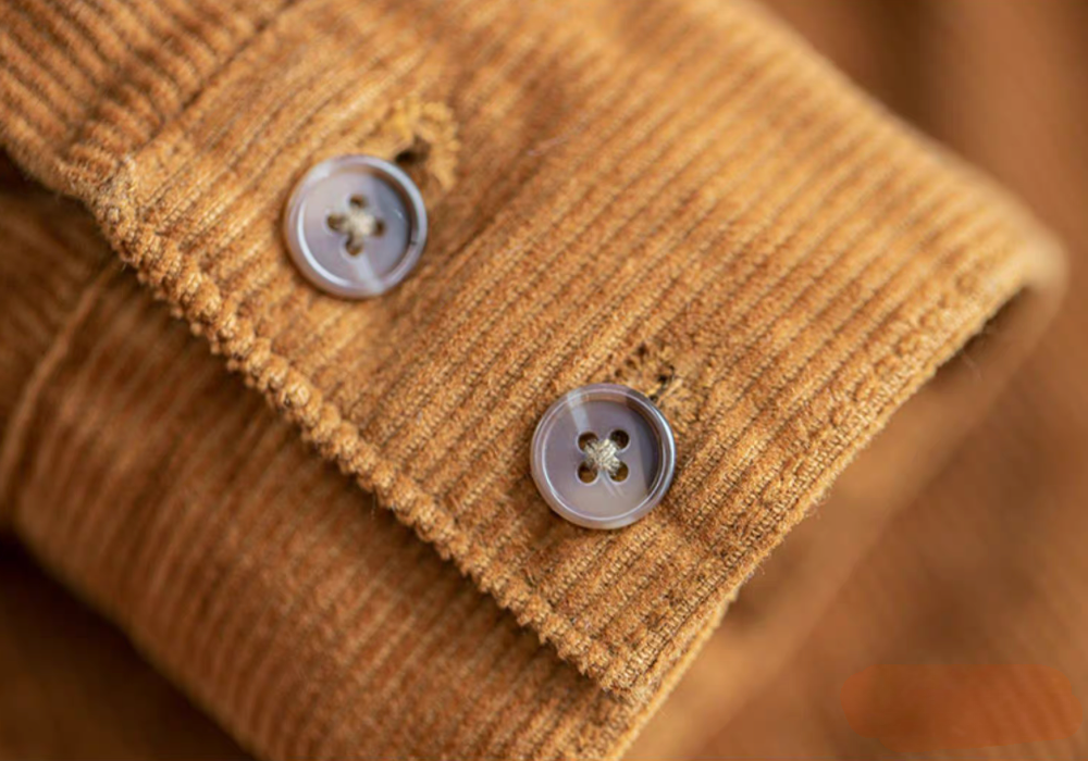Detail of Amber Corduroy Field Shirt sleeve cuff with buttons highlighting textured corduroy fabric and stitching