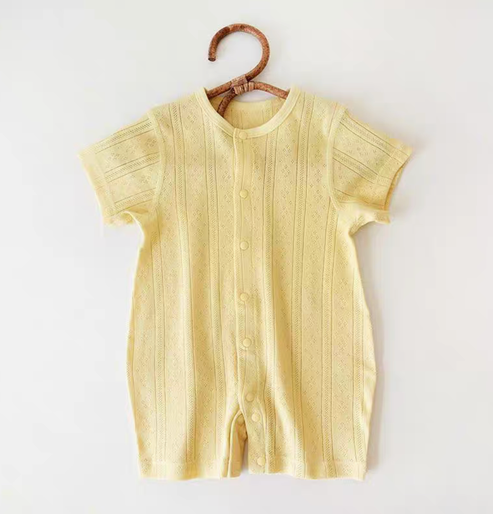 Light yellow cotton baby romper hanging front view soft summer color with breathable fabric