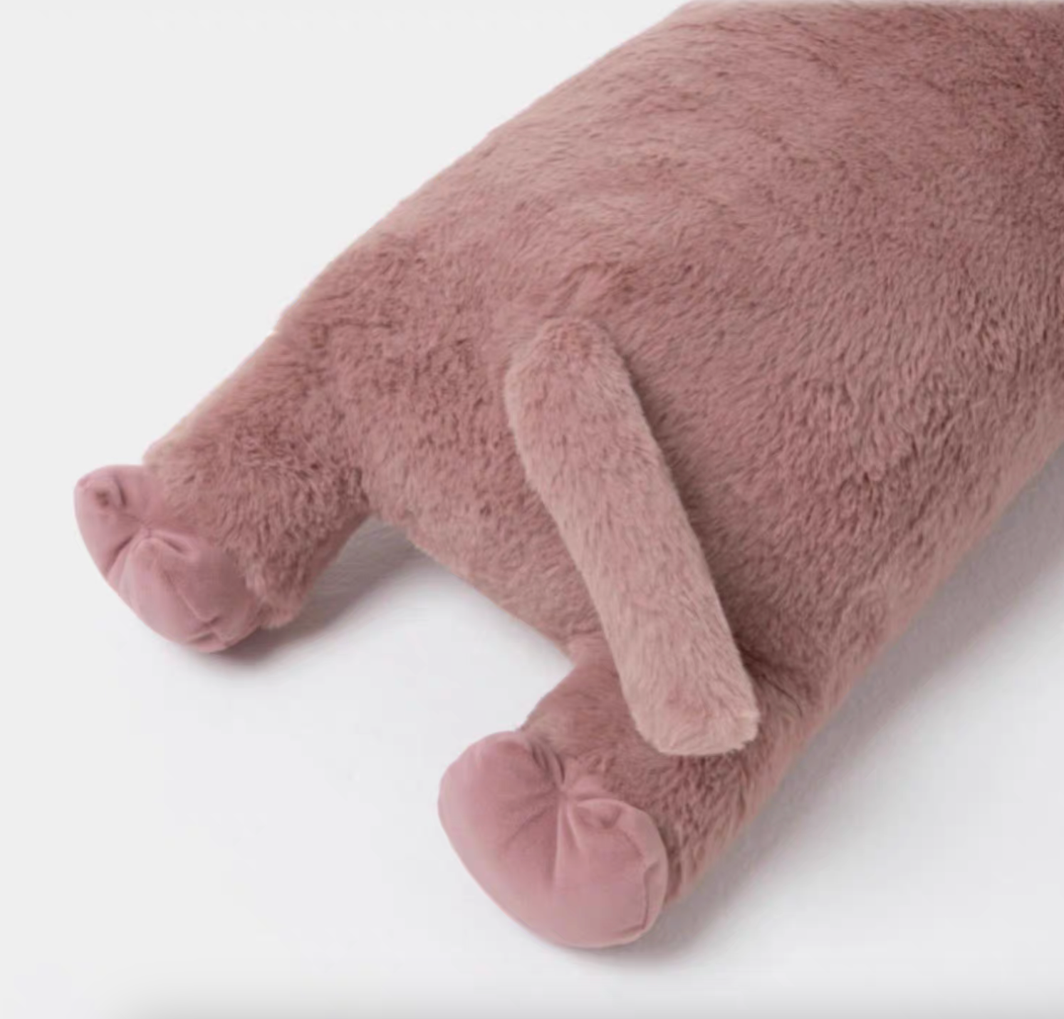 Close-up of pink hippo long body pillow back legs and tail highlighting soft plush texture