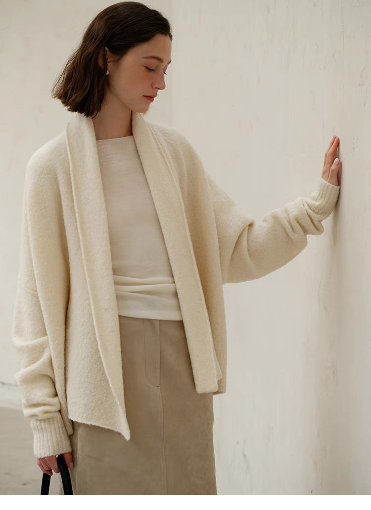 Angled front view of Cozy Elegance Oversized Knit Cardigan in Ivory showing open front design, ribbed cuffs, and refined minimalist style