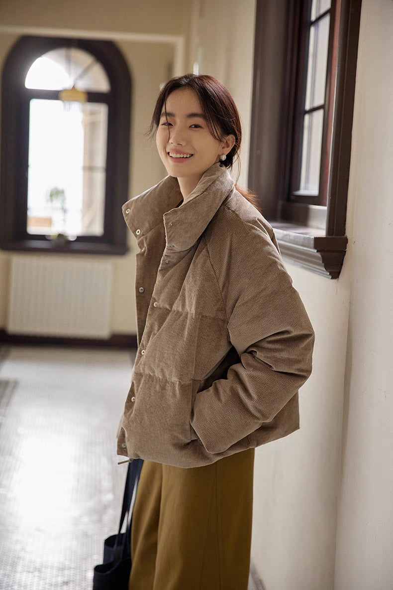 Angled side view of Cozy Quilted Corduroy Coat in light brown gray showing corduroy texture, snap button closure, and casual winter styling