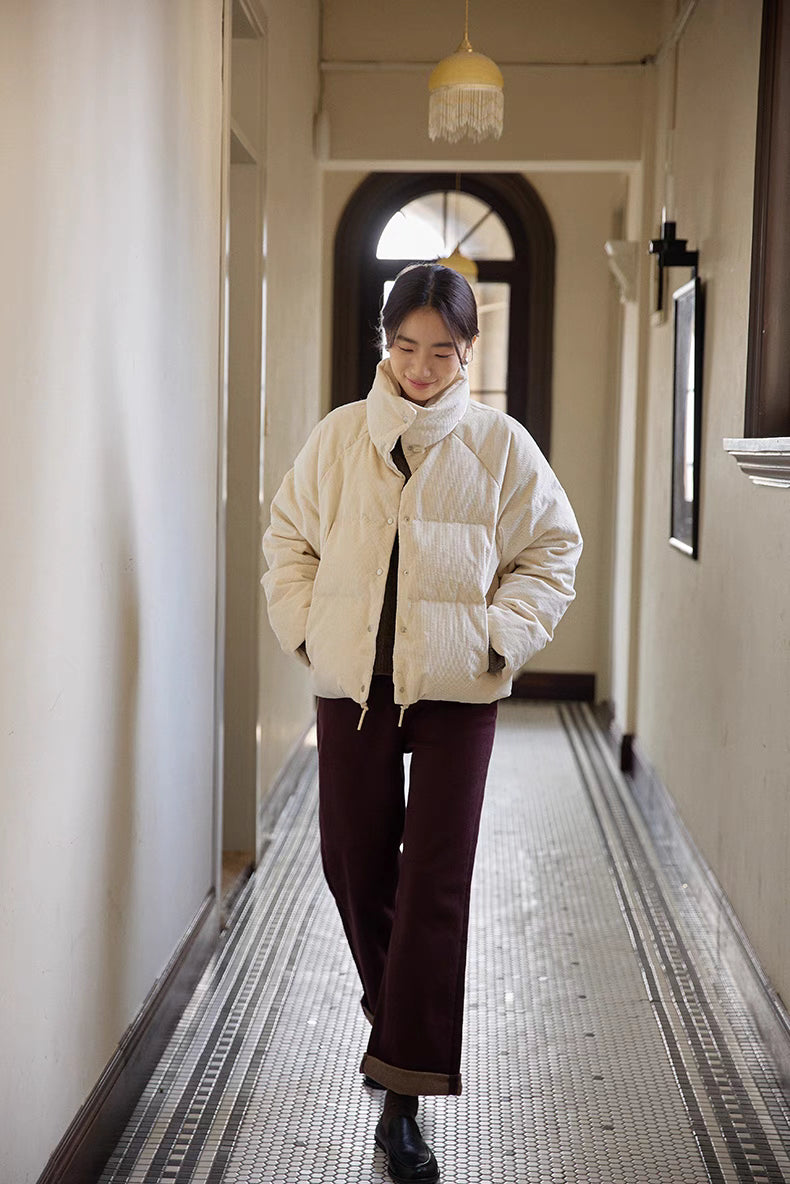 Full-body walking view of Cozy Quilted Corduroy Coat in off white featuring oversized silhouette, short length design, and casual layering look