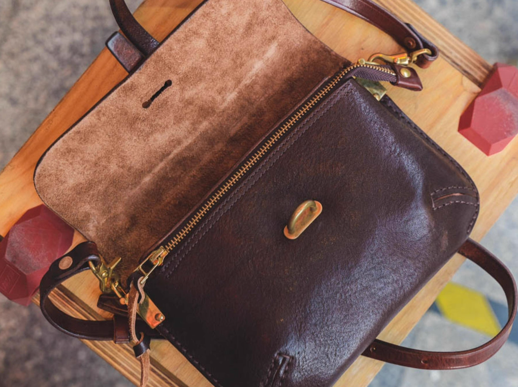 Open view showing suede interior and YKK brass zipper of handcrafted Italian leather bag