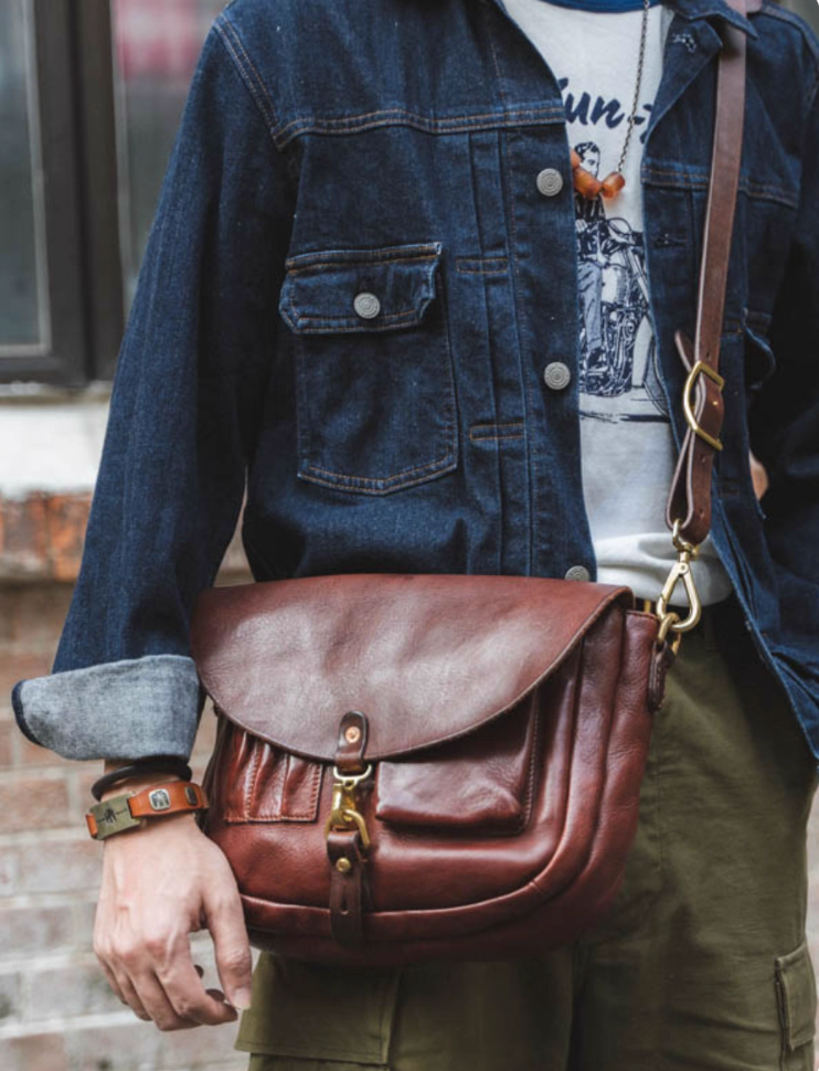 Front view of washed Italian leather messenger bag worn crossbody