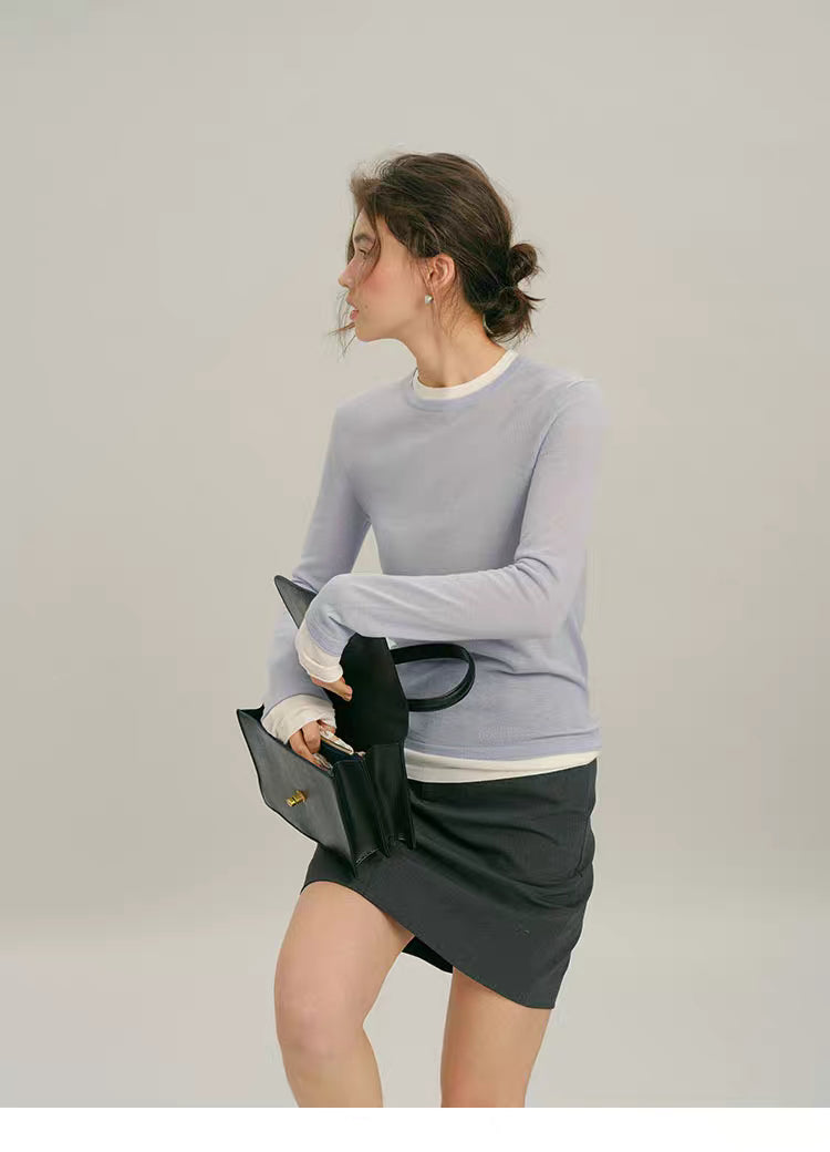 Dusty Blue mock-layered wool top, motion pose while holding handbag