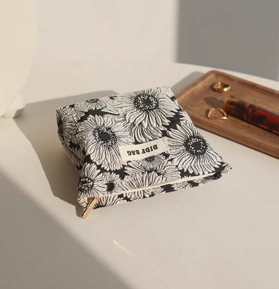 Daisy Daisy Travel Makeup Bag flat lay front view showing floral pattern and structured shape
