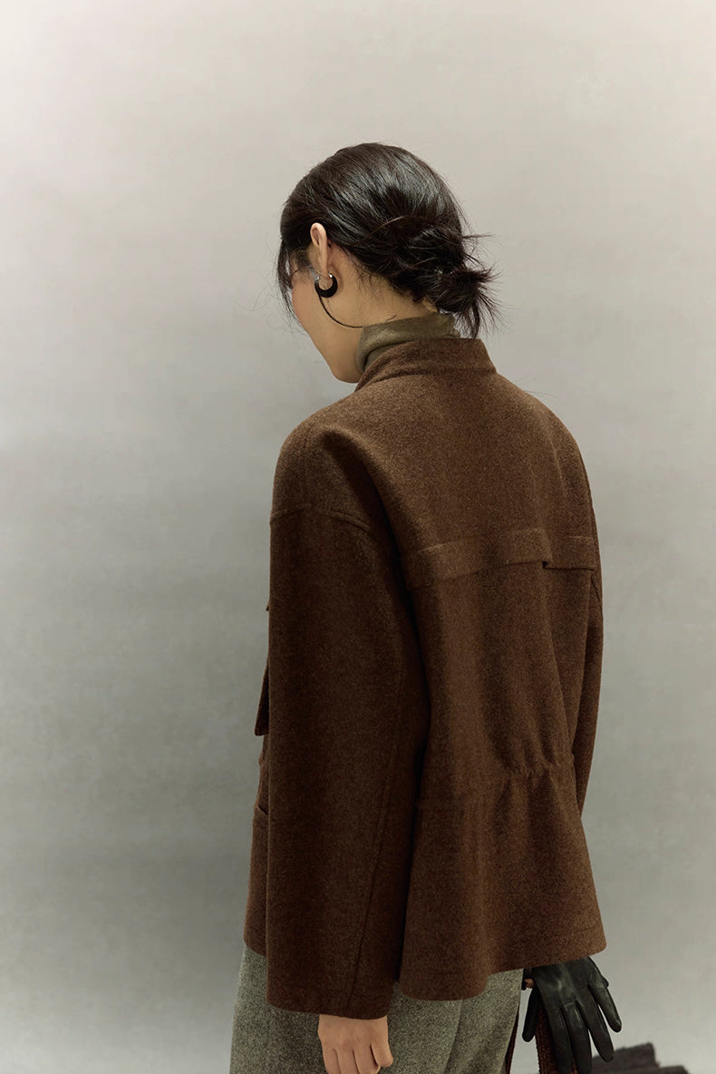 Back view of dark coffee wool field jacket with subtle gathered waist and soft drape