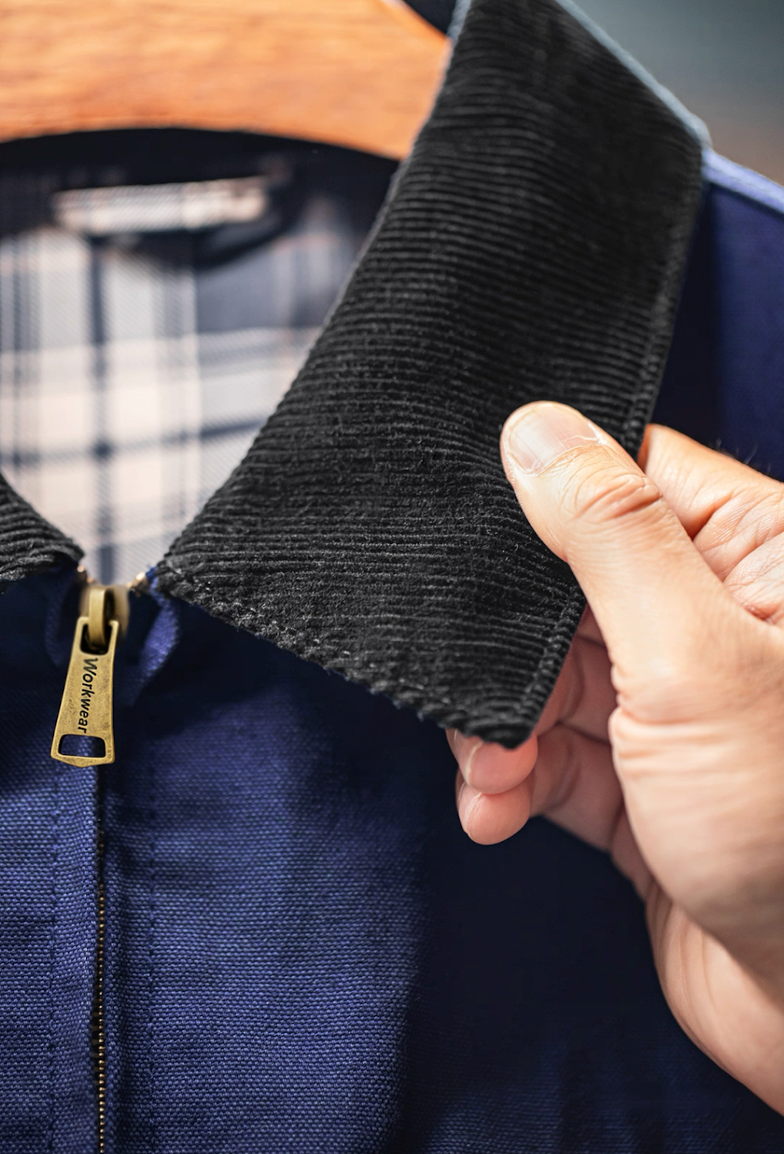 Corduroy collar close-up on navy Detroit work jacket with plaid lining