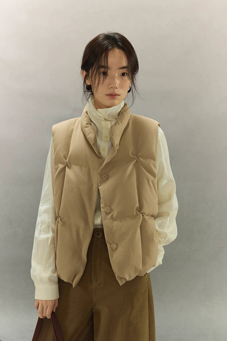 woman wearing beige sculpted down vest in front view