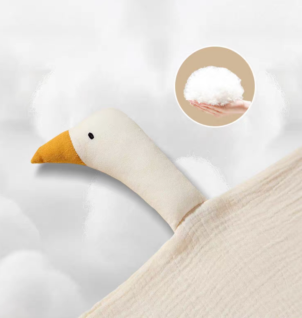 Close-up of cream duck lovey showing soft cotton head, stitched eye detail, and plush filling texture