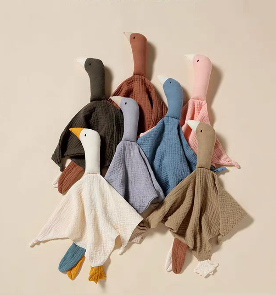 Multiple duck lovey teething toys grouped together in different colors showcasing variety of soft cotton comfort blankets