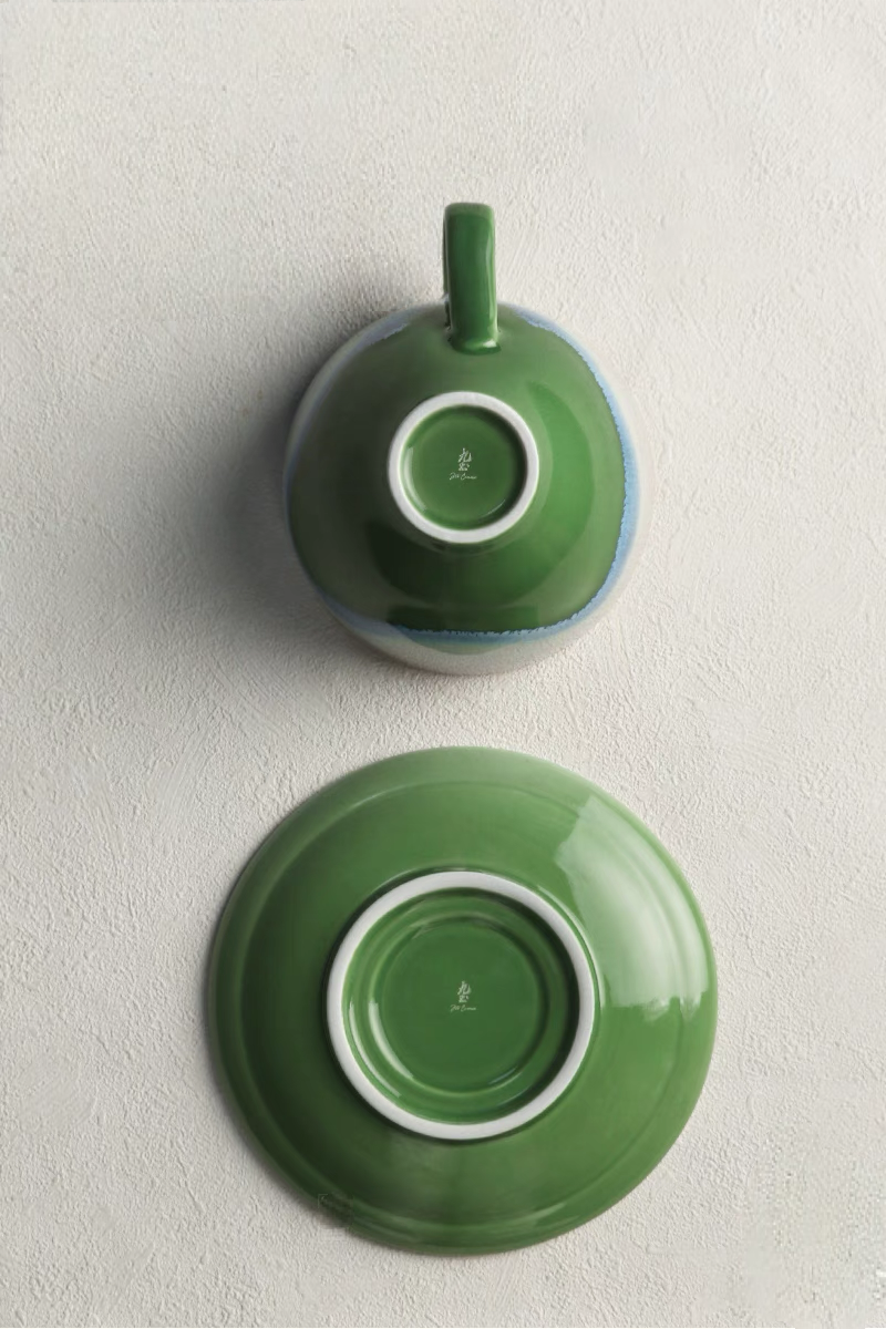 Kiln-Change Green ceramic coffee cup and saucer bottom view showing base detail and glazed underside finish