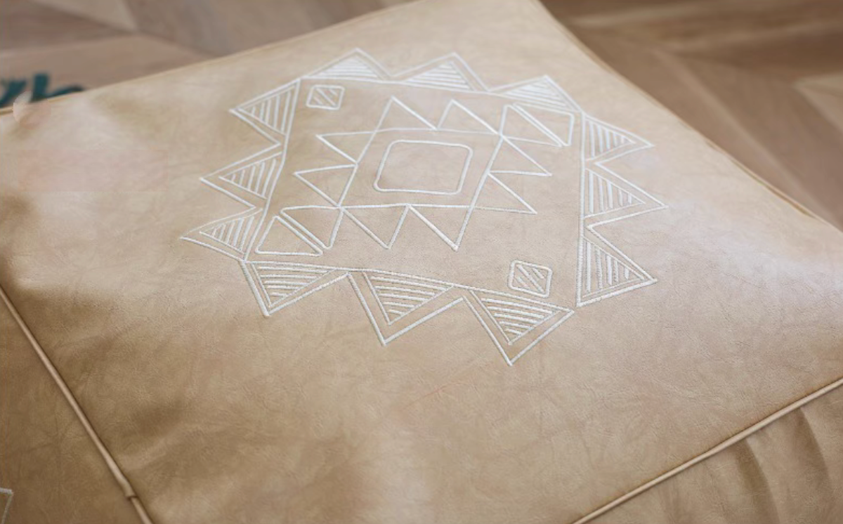 Close-up of khaki embroidered square bean bag sofa showing detailed white geometric stitching on PU surface