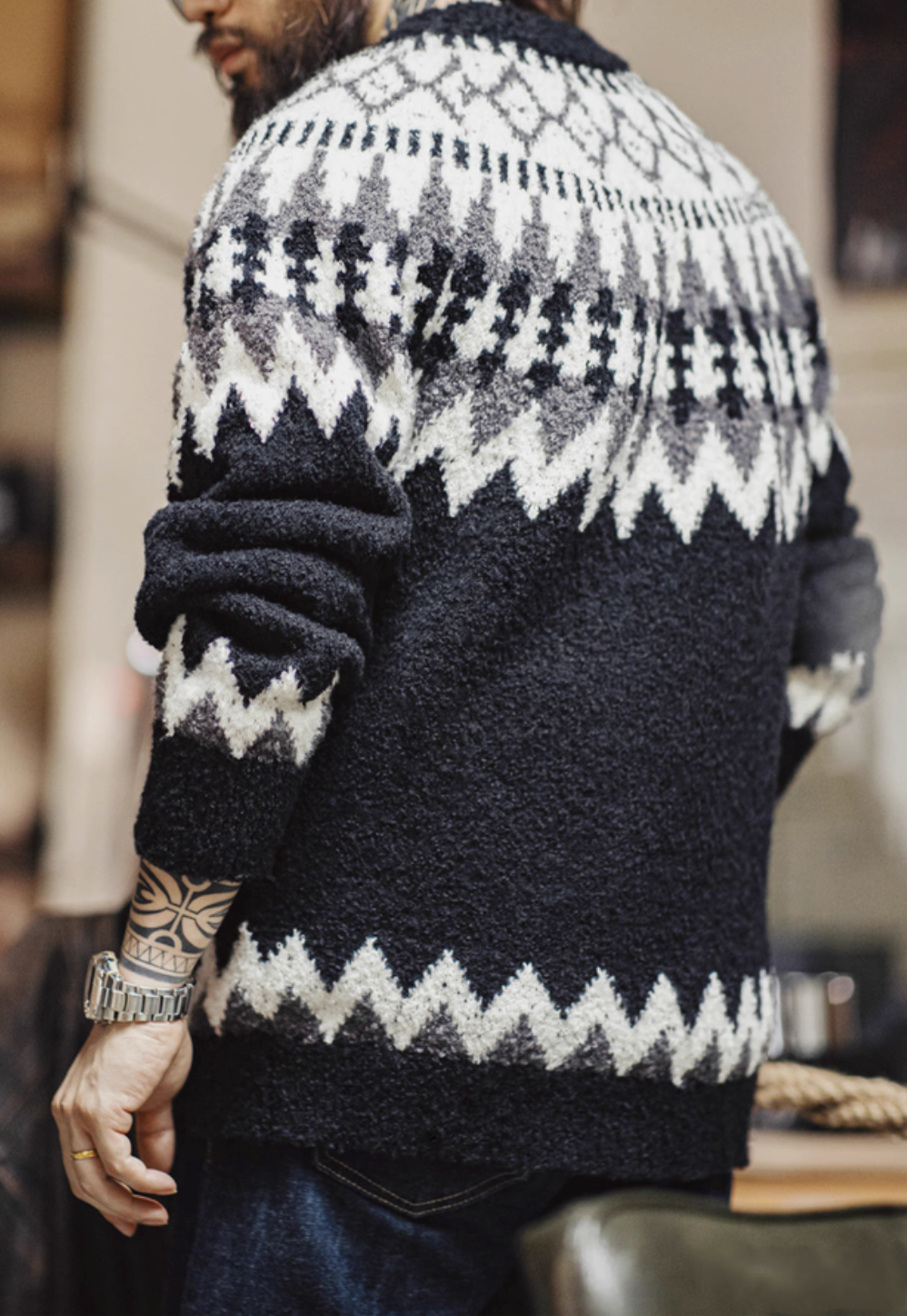 Back view of Glacier Peaks Knit Sweater Black White Gray showcasing continuous geometric pattern ribbed hem and relaxed silhouette