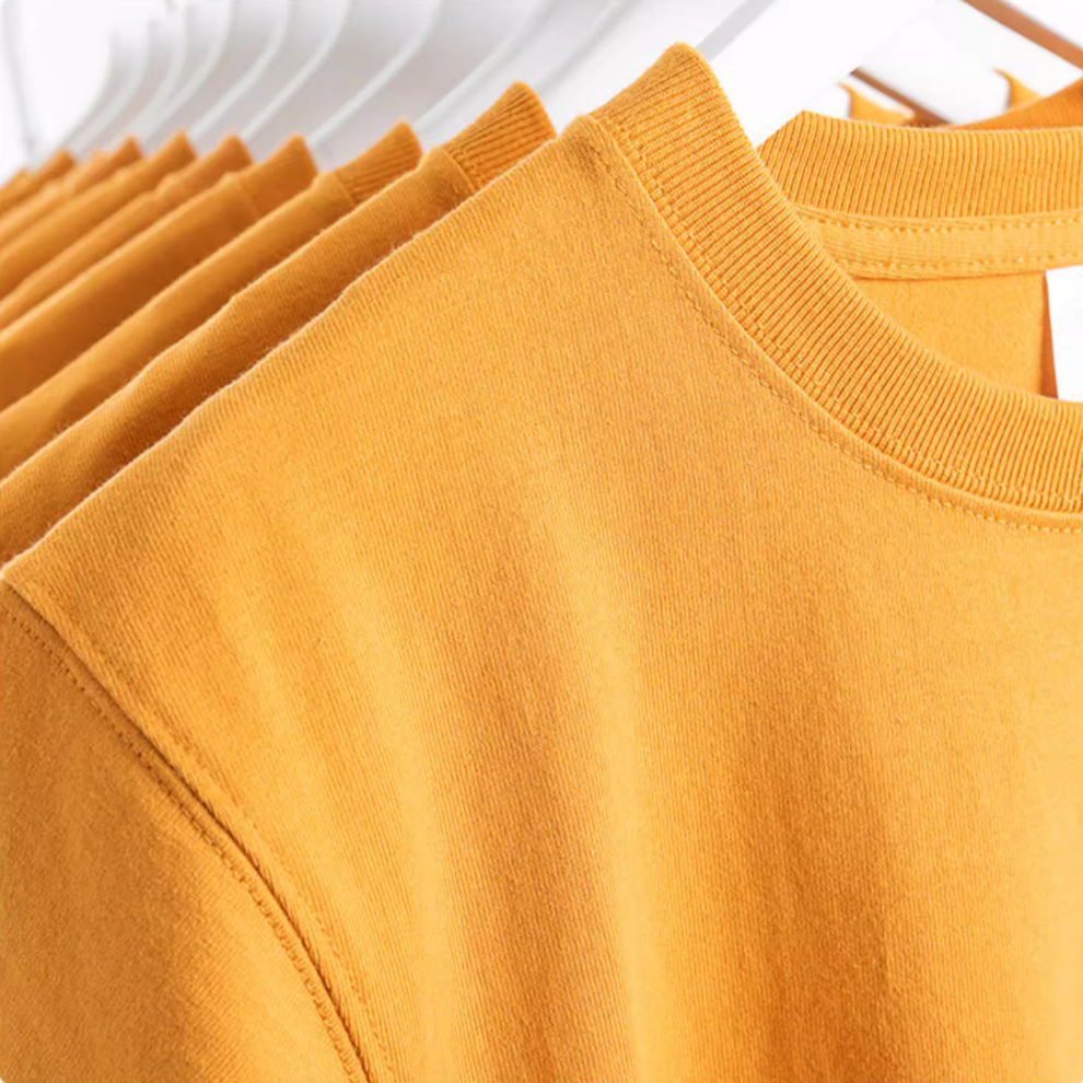 Golden Glow Tee mustard yellow color folded stack detail showing smooth cotton fabric and stitching