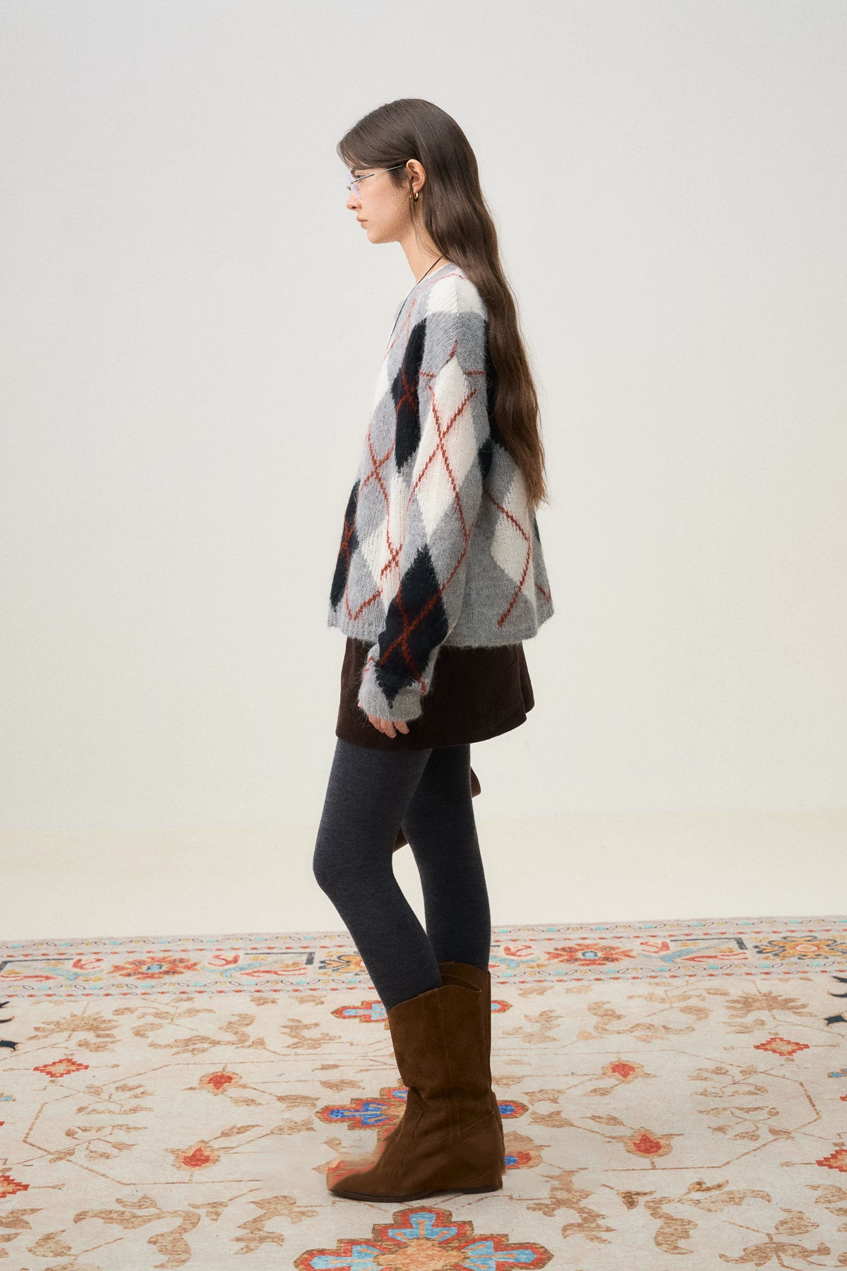 Side profile of a Gray Argyle brushed alpaca-blend sweater with dropped shoulders and hip length