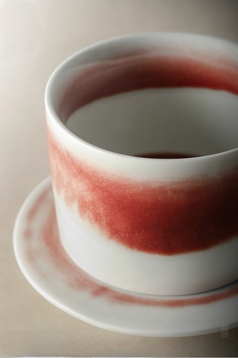 Style 2 ceramic cup close-up showing fine crimson glaze texture and smooth handcrafted finish