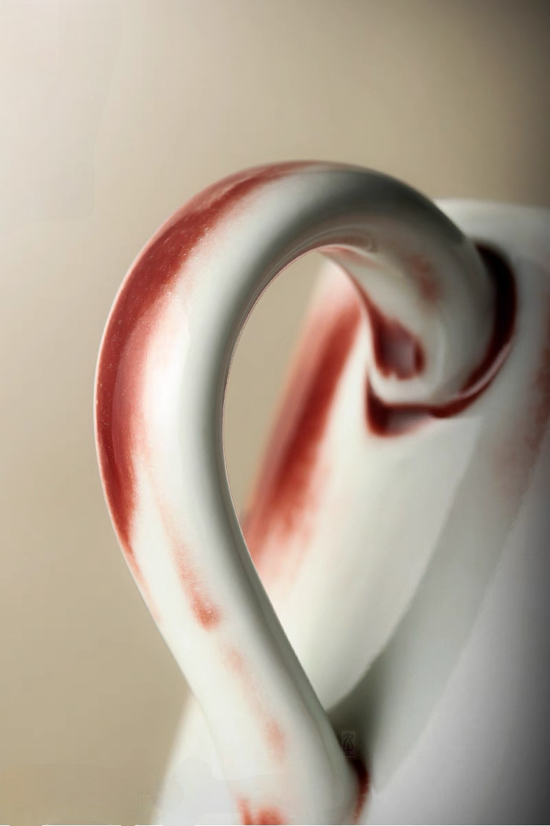 Style 2 ceramic cup close-up of curved handle with red glaze accents emphasizing craftsmanship and grip comfort