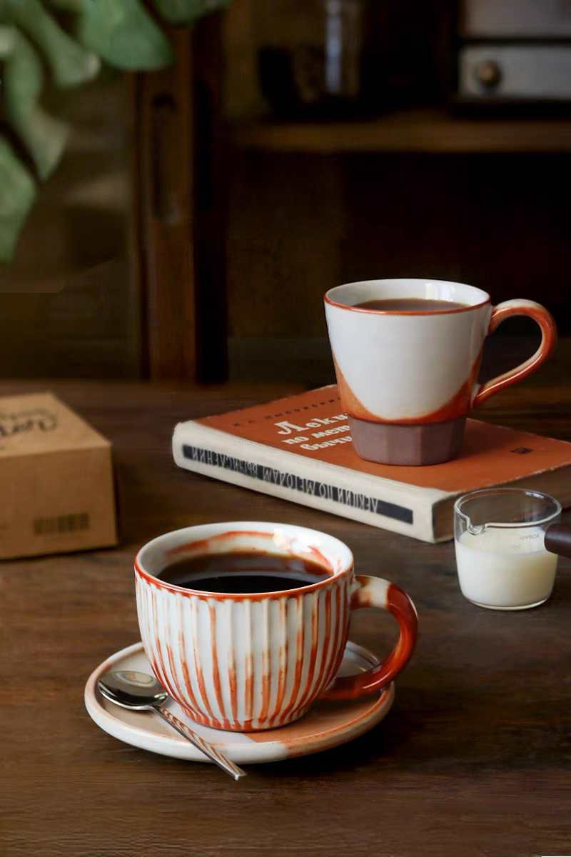Style 1 handcrafted ceramic ridged cup and saucer set in off-white and orange shown in clean front product view