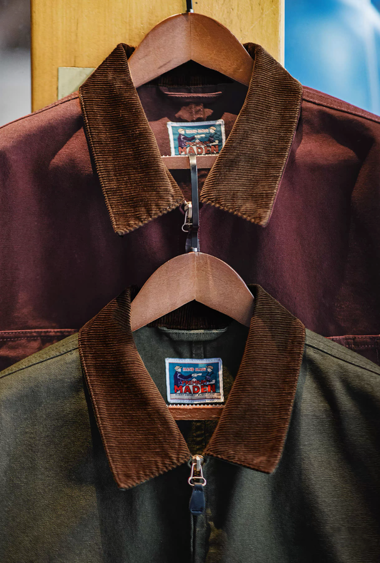 The green and burgundy Hardman Detroit 90s Workwear Jackets hanging side by side, showing their distinct corduroy collars.