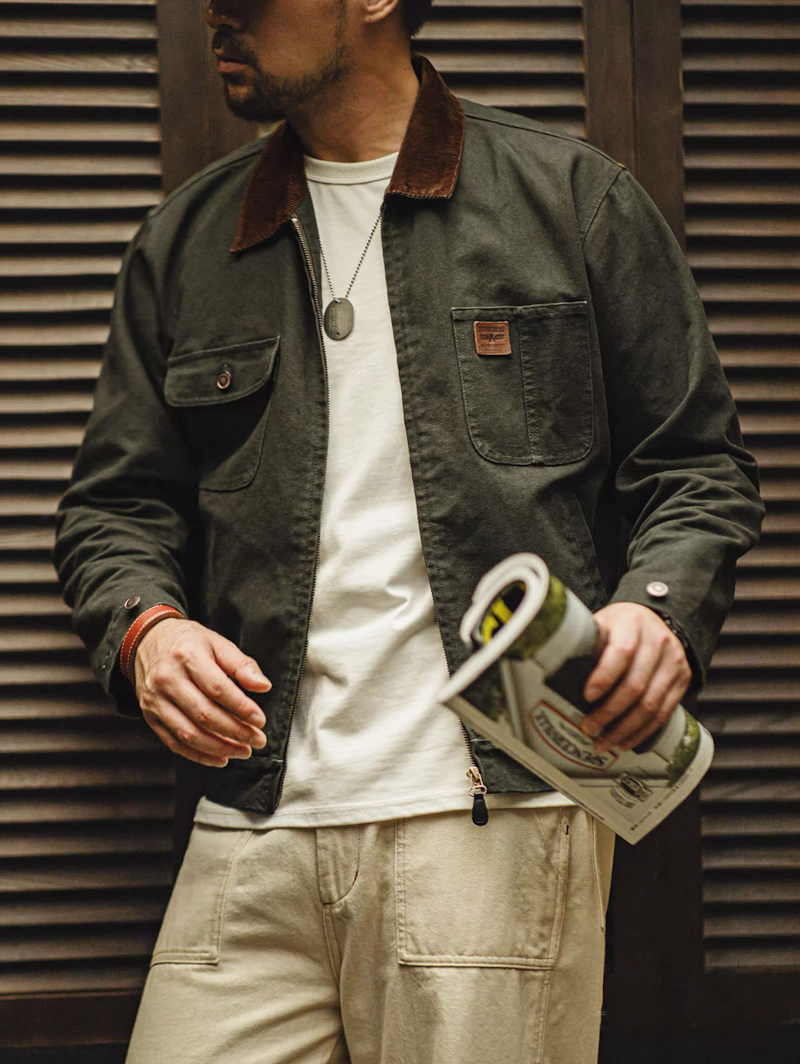 Model wearing the green Hardman Detroit 90s Workwear Jacket with a simple white tee and beige pants, styled for a casual look.