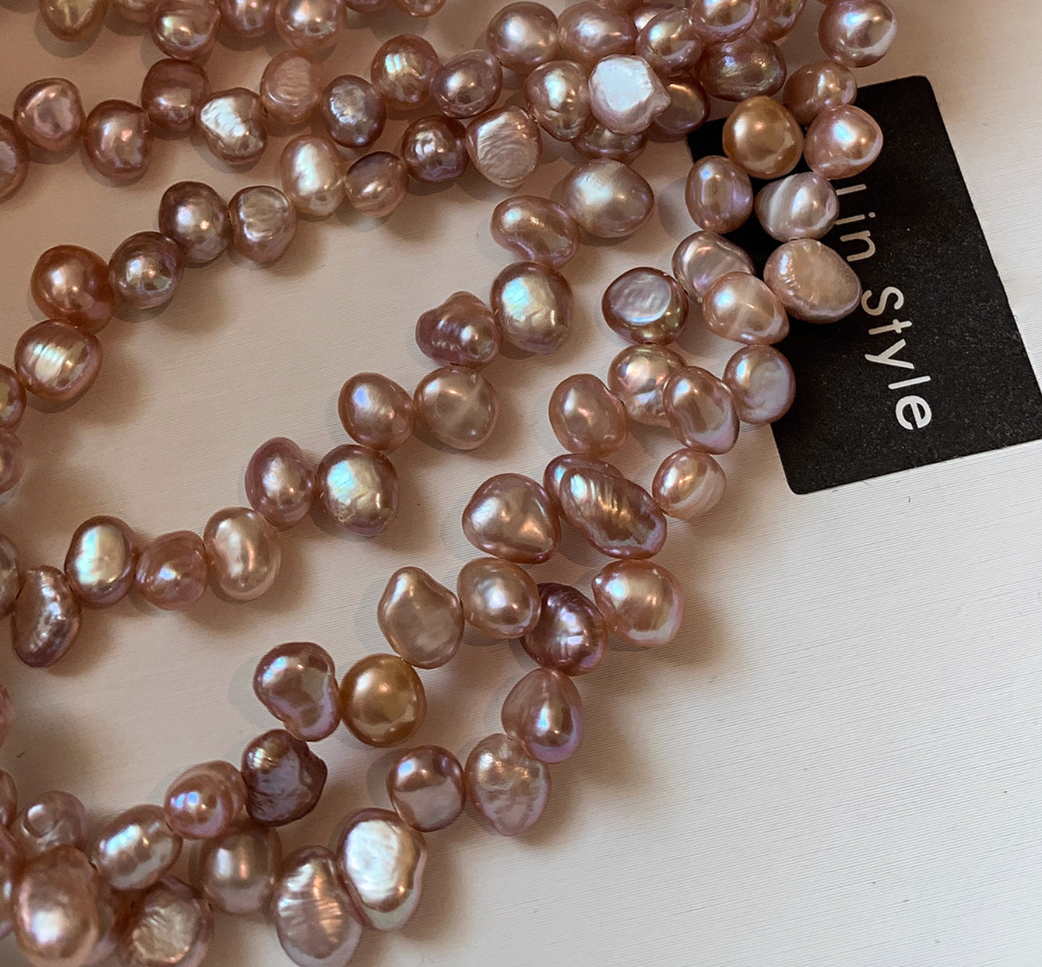 Close-up of champagne pink baroque freshwater pearls with natural irregular shapes and soft iridescent luster