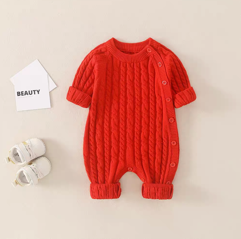 Red cable knit baby romper front view with side button design and textured knit pattern
