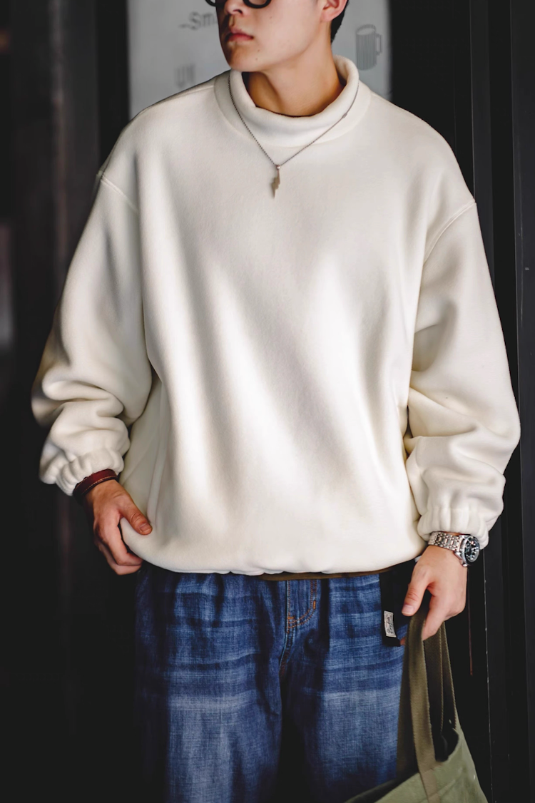 Model wearing Cream White Fleece Sweatshirt front view indoor