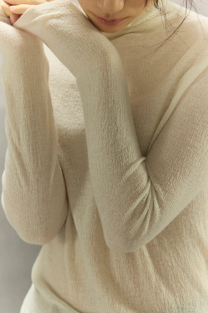 Close-up of bark-texture knit and seamless sleeve detail in Ivory White.