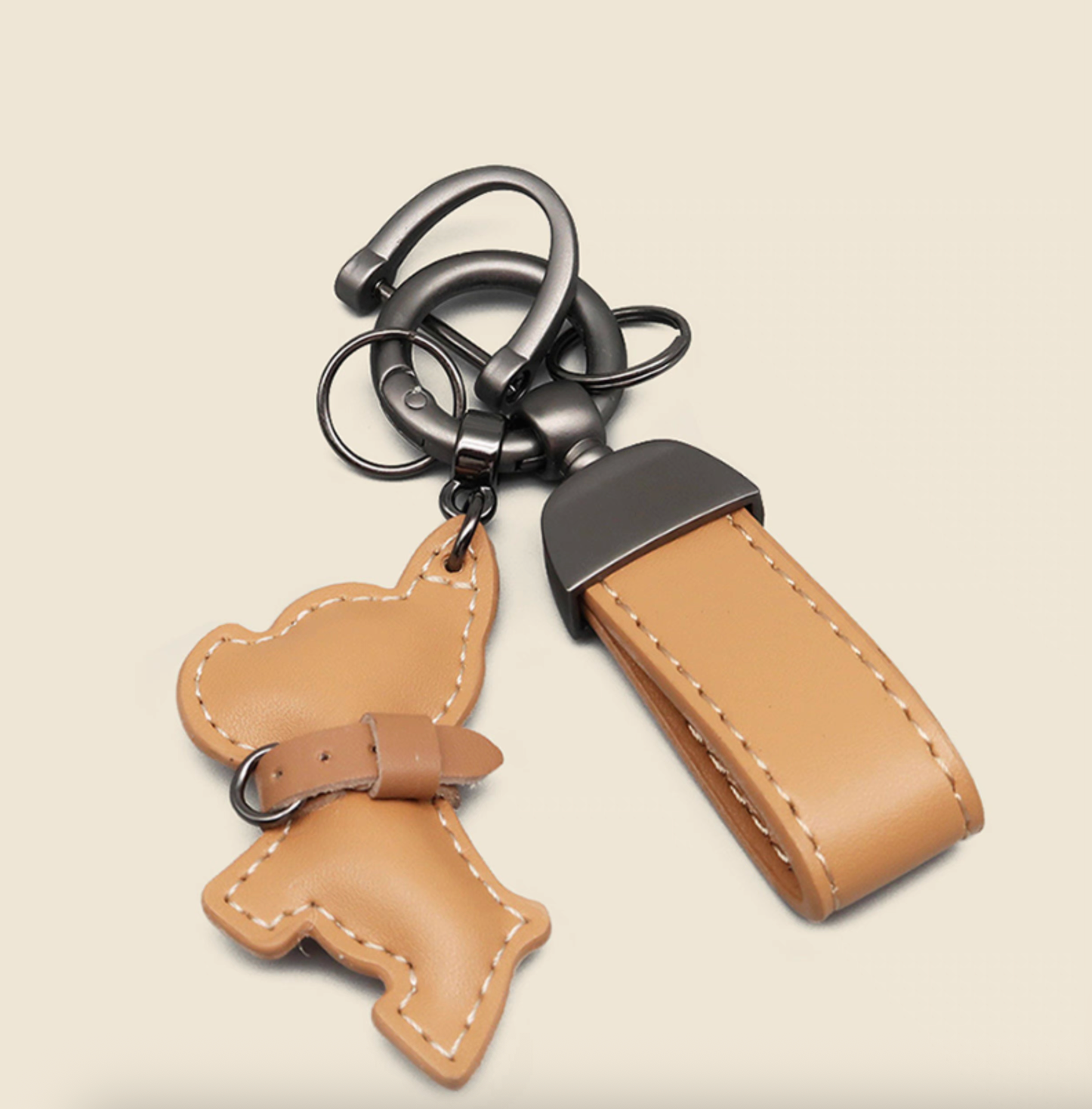 Light brown PU leather puppy keychain with wrist strap and gunmetal hardware.