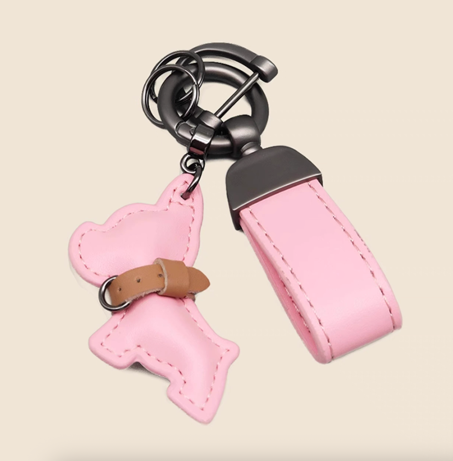 Pink PU leather puppy keychain with stitched dog charm and matching strap.