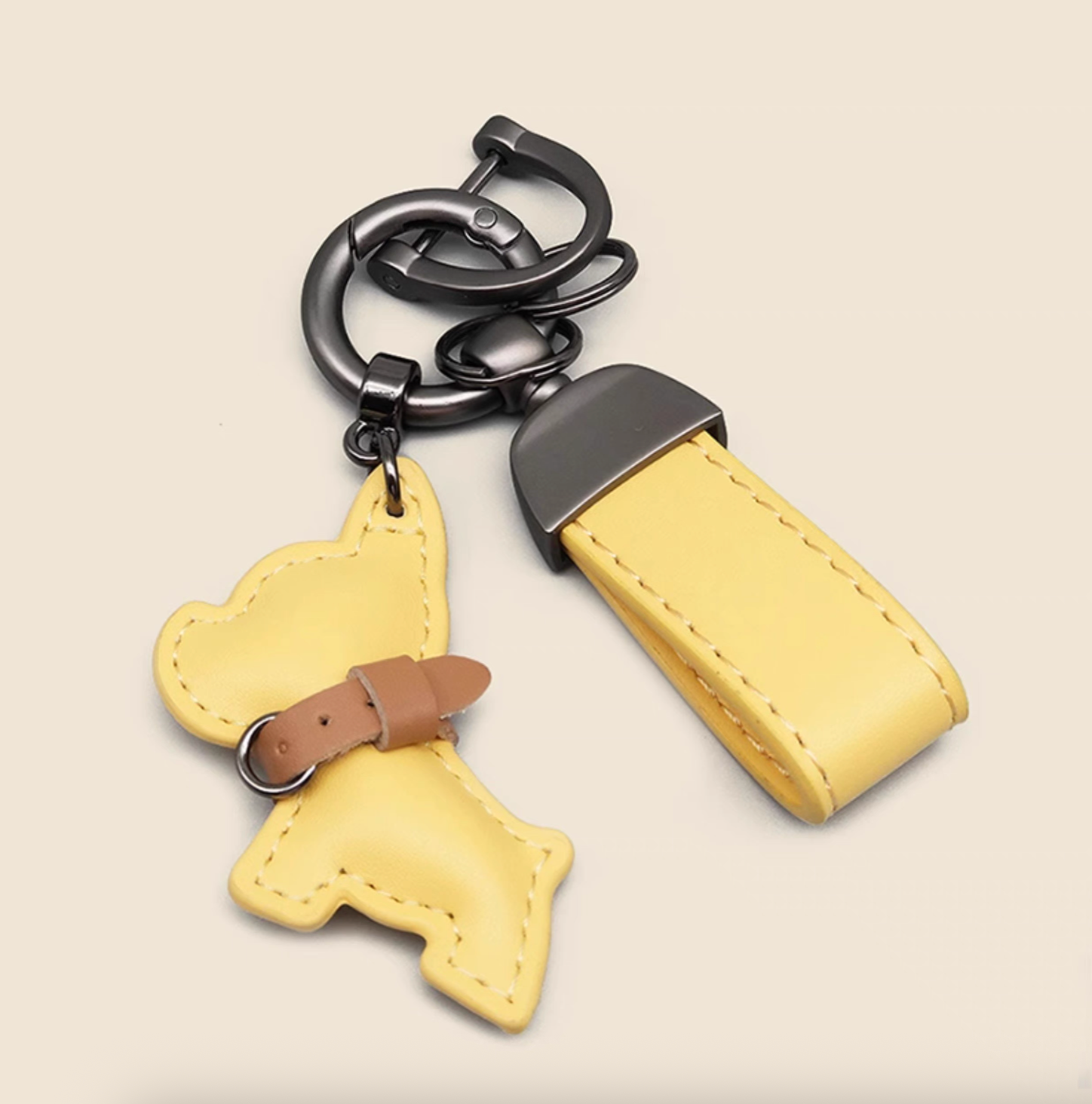 Yellow PU leather puppy keychain with mini dog charm and wrist strap.