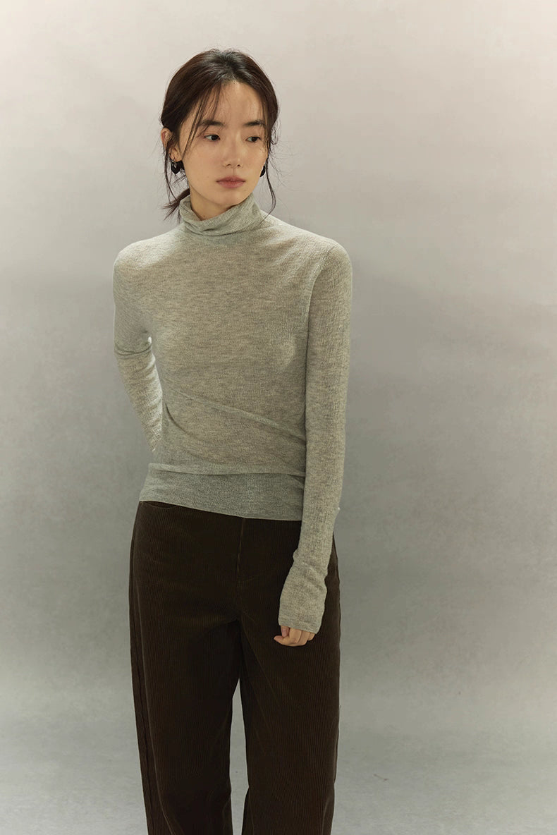 Model wearing Light Gray seamless turtleneck, full-body front view.