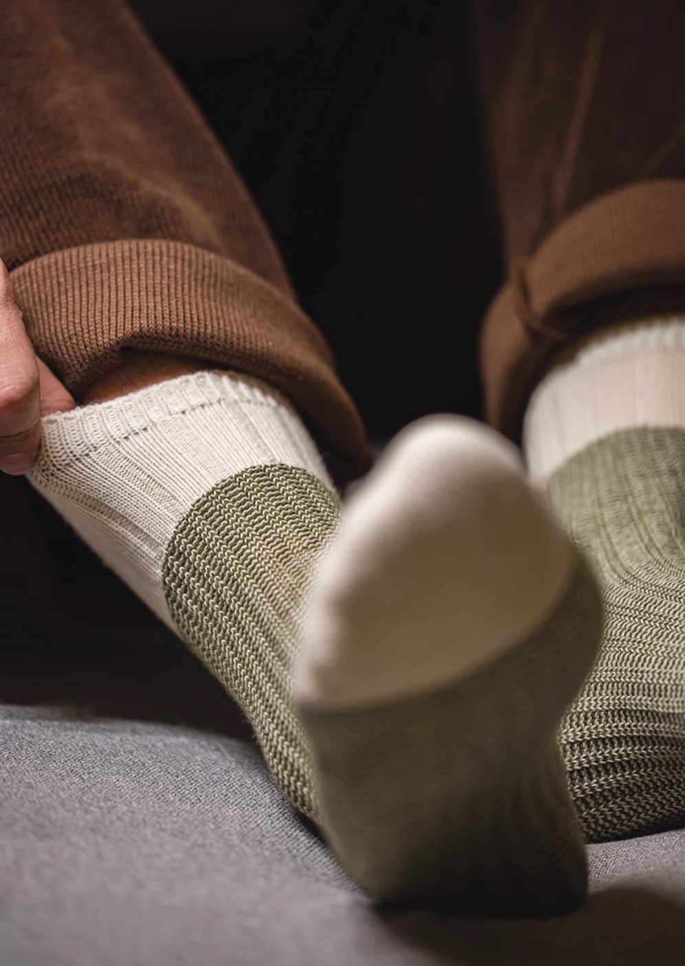 Lucky Chunky Knit Socks in moss green worn with feet raised showing sole view and detailed chunky knit pattern