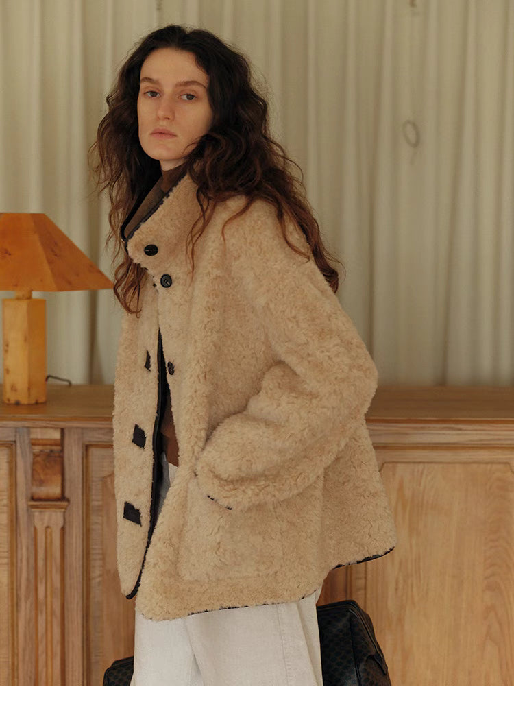 Side view of Luxe Contrast Shearling Coat in Apricot Beige short style showing relaxed fit, front welt pocket, and soft shearling texture