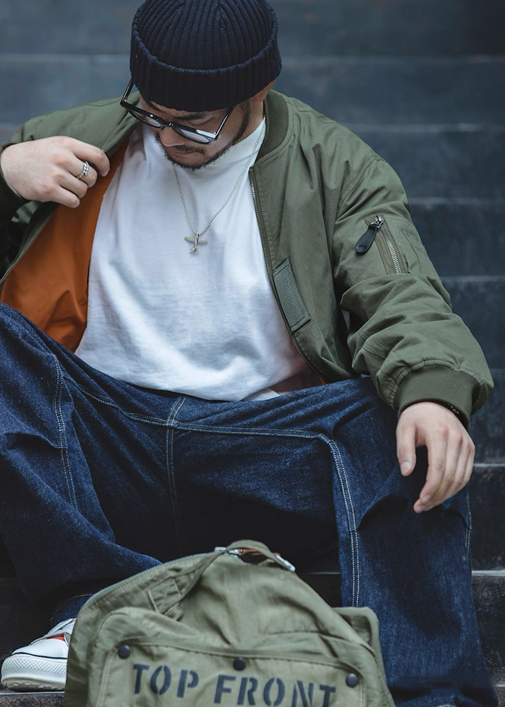 Street look with green MA-1 bomber jacket and denim