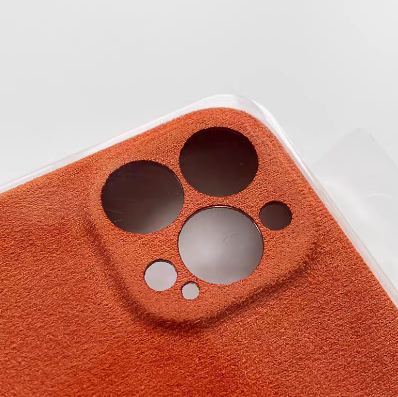 Orange microfiber suede phone case close-up of camera cutout and textured matte finish