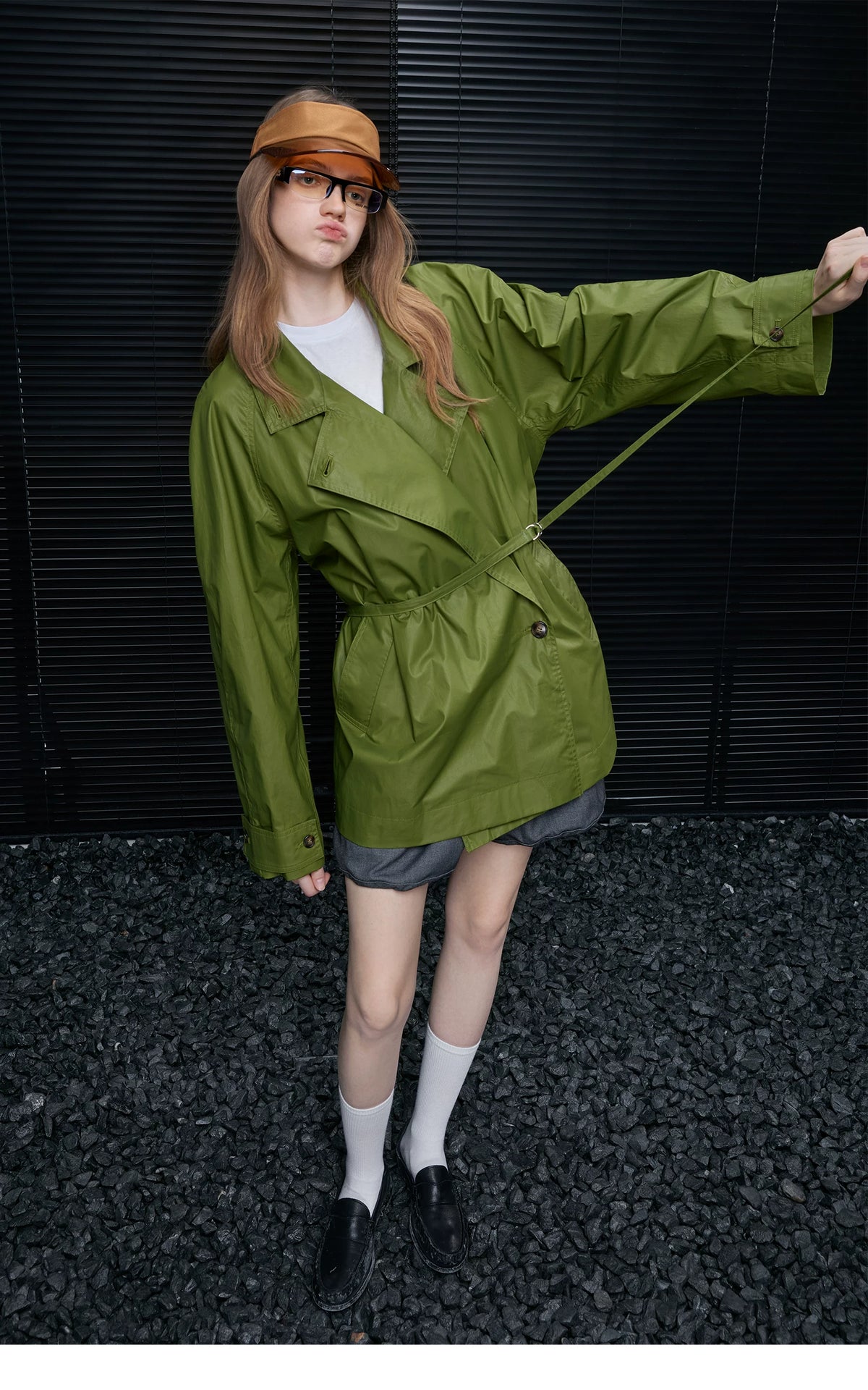 Moss Green trench jacket cinched with its D-ring belt over an asymmetric button front