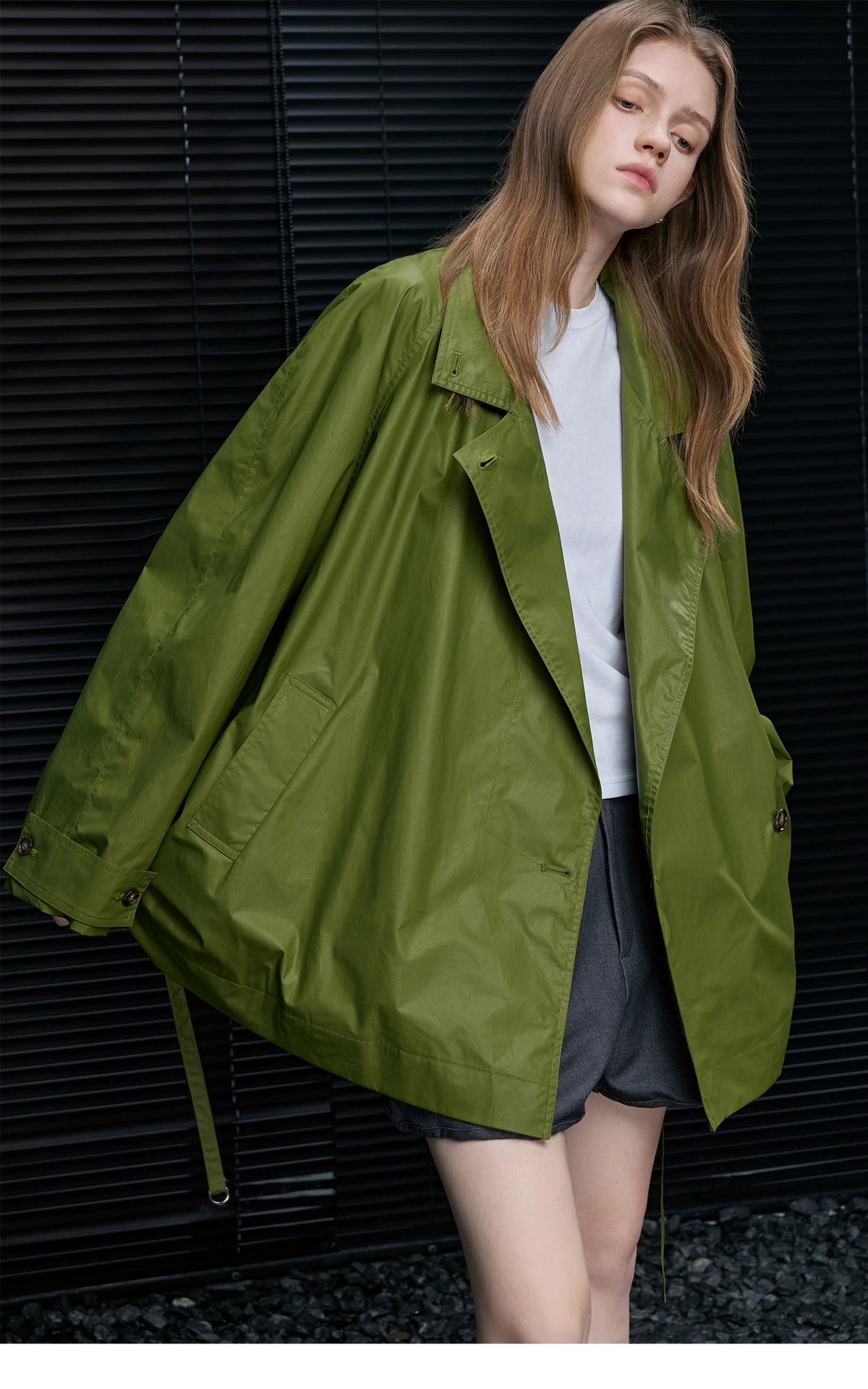 Moss Green cotton trench jacket with wide notched lapels, raglan sleeves, and button-tab cuffs