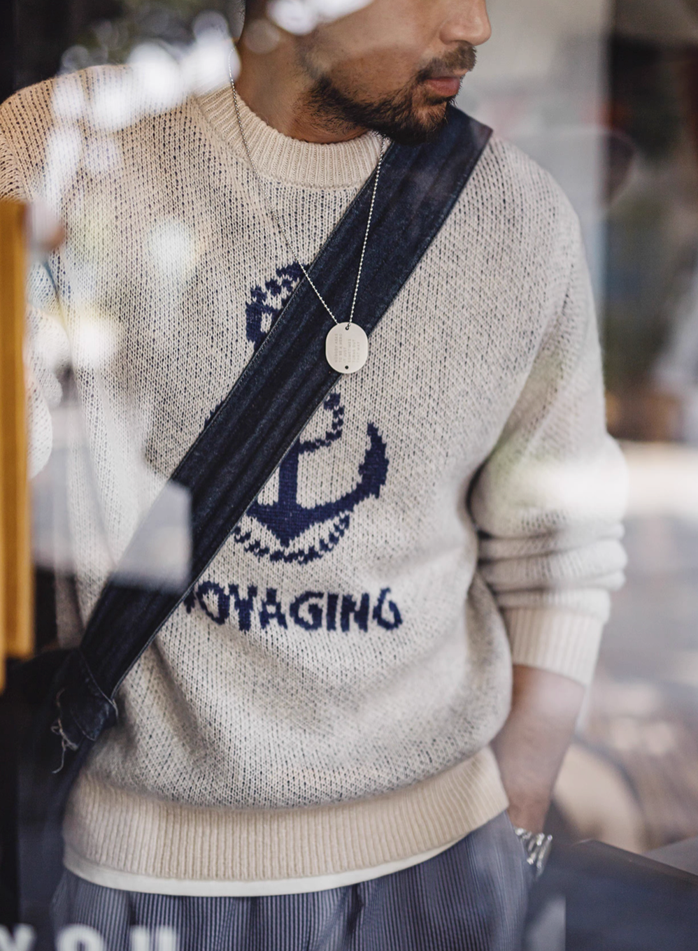 Nautical Anchor Knit Sweater Gray Blue worn with crossbody strap highlighting anchor design and ribbed hem detail