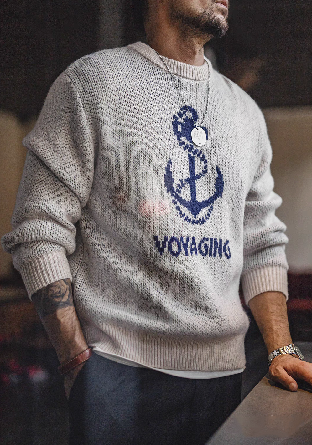 Man wearing Nautical Anchor Knit Sweater Gray Blue showing relaxed fit and anchor graphic in casual indoor setting