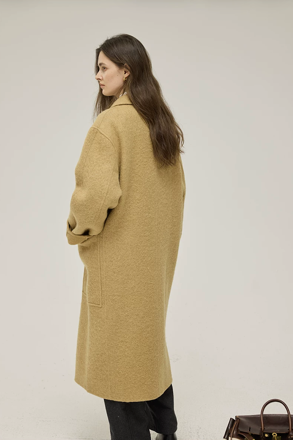 Back view of an Ochre straight-cut wool coat showing dropped shoulders and mid-calf length