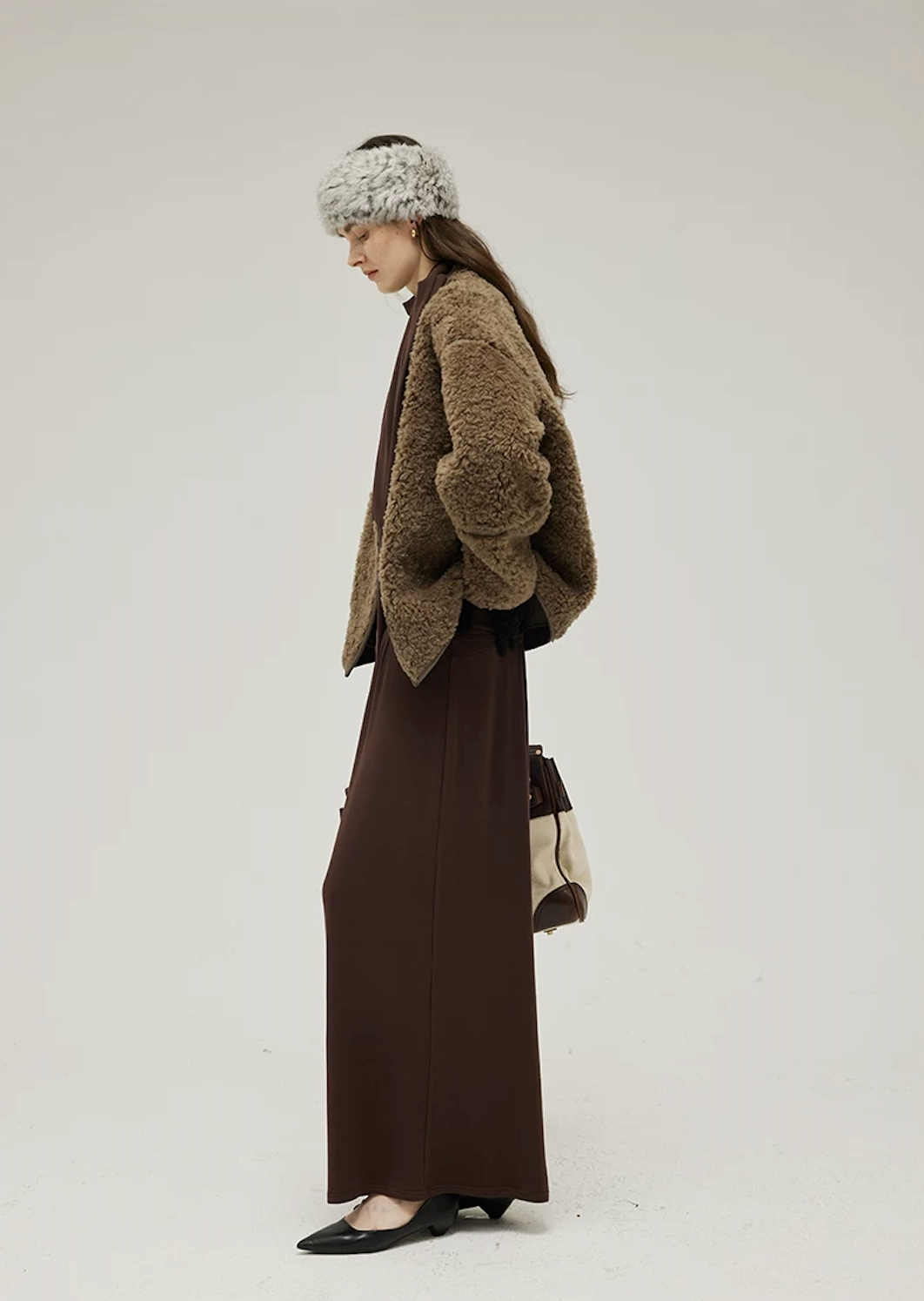 Side view of an Olive Brown curly wool teddy jacket with dropped shoulders and straight hem