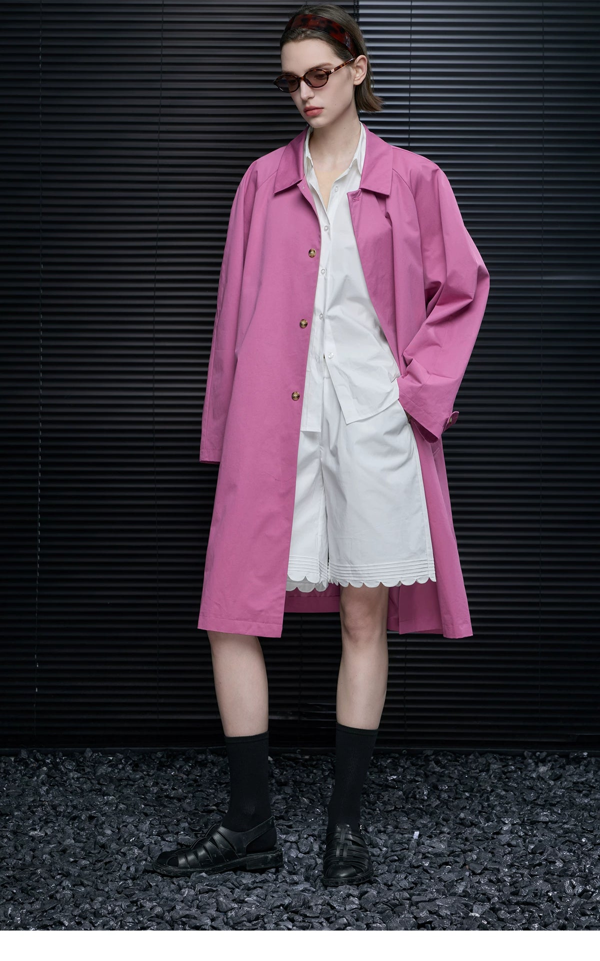 Full-length view of an Orchid Pink below-the-knee swing coat worn open with buttoned cuff tab