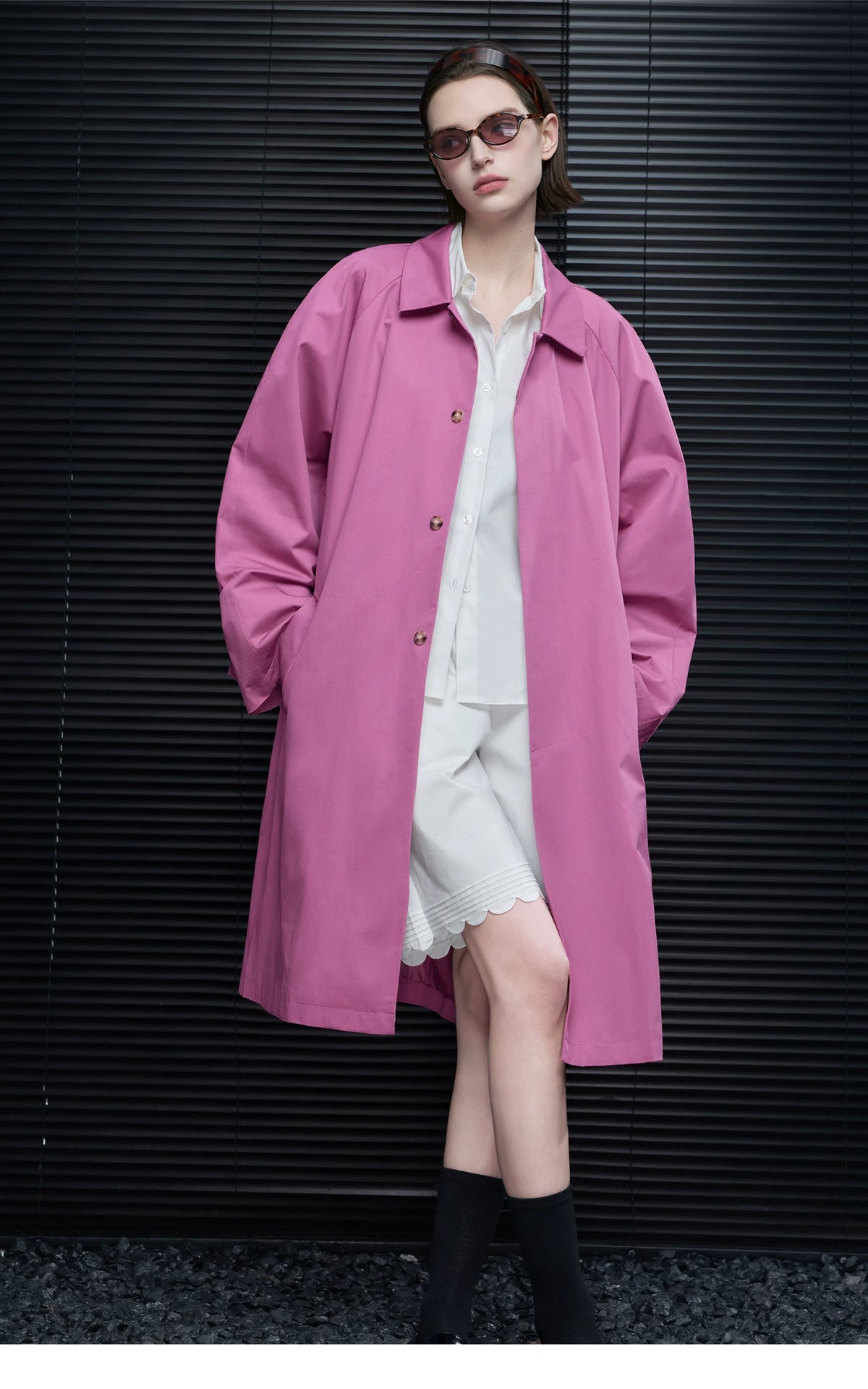 Orchid Pink oversized cotton coat worn open with point collar and hands in the side pockets