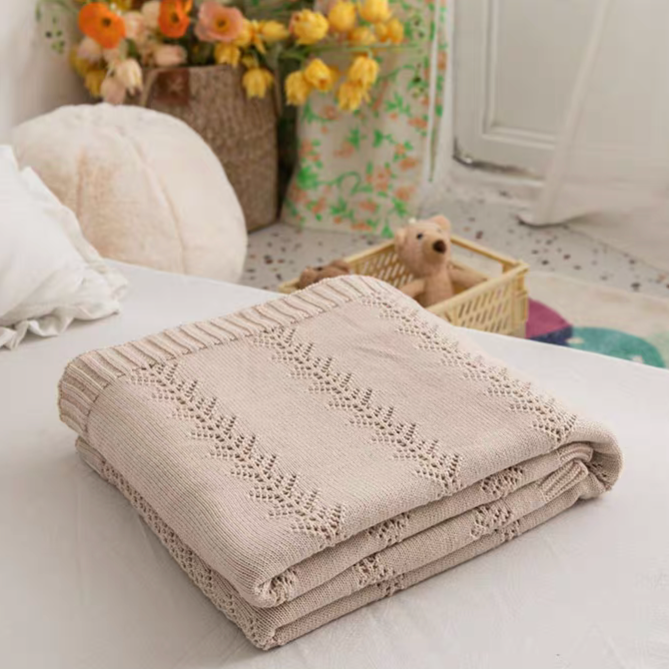 Folded Cream White Oversize Knit Throw Blanket displayed on bed highlighting lightweight cotton knit texture