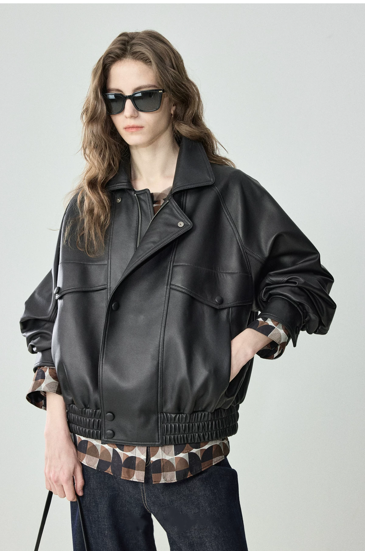 Black oversized lambskin moto bomber with point collar, off-center zip and flap chest pockets