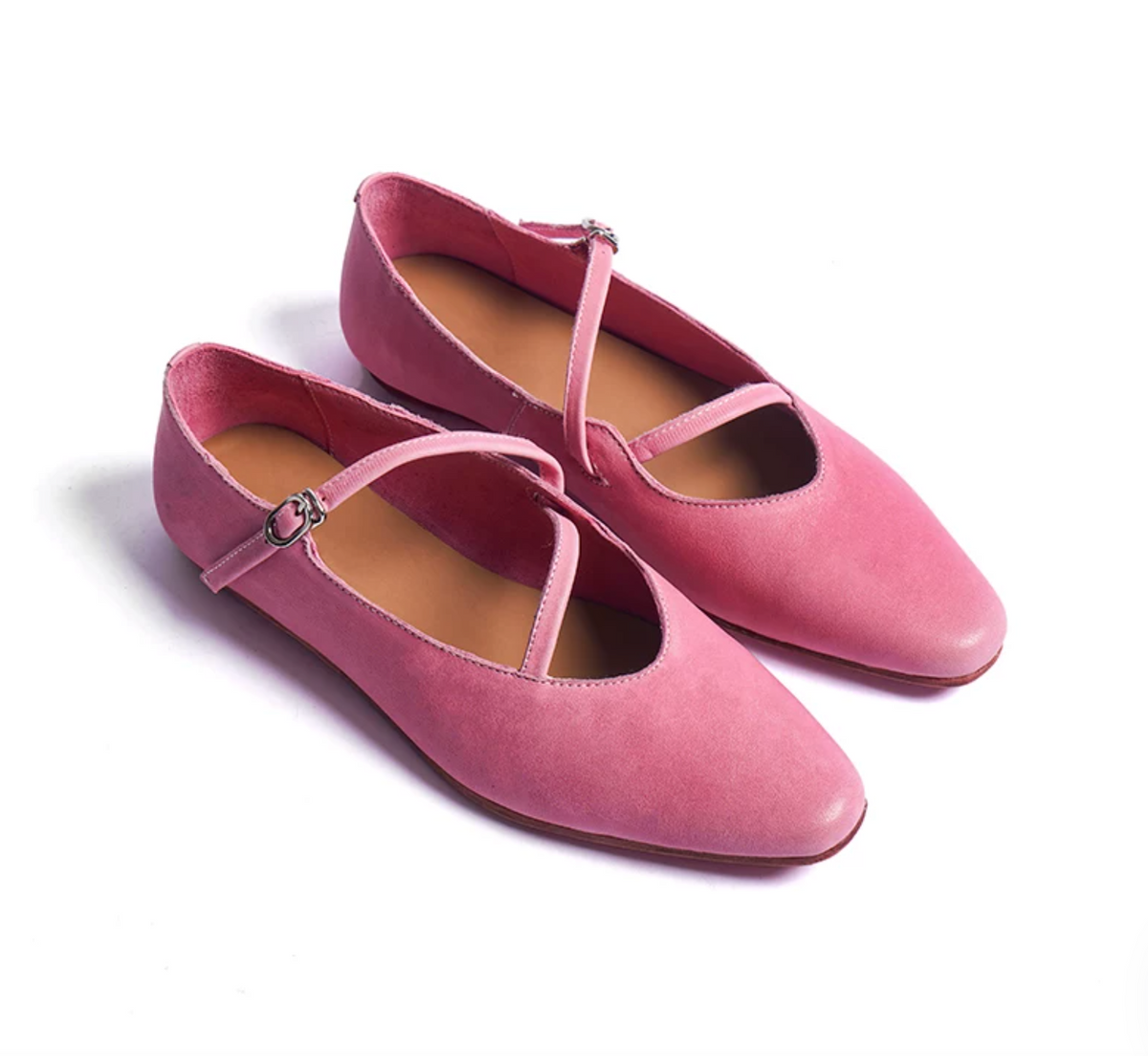 Pair of Pink washed leather ballet flats with looping crisscross straps and silver-tone buckles